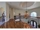 Grand foyer with hardwood floors, a decorative chandelier, and wrought iron banisters at 8710 Merion Dr, Duluth, GA 30097