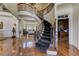 Elegant home foyer showcasing winding staircase, hardwood floors, and grand entrance at 8710 Merion Dr, Duluth, GA 30097