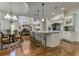 Well-appointed kitchen with an island, pendant lighting, and hardwood floors, adjoining a cozy dining area at 8710 Merion Dr, Duluth, GA 30097