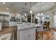 Bright kitchen features granite countertops, an island with bar seating, and stainless-steel appliances at 8710 Merion Dr, Duluth, GA 30097
