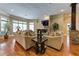 Inviting living room with hardwood floors, a stone fireplace, and large windows for natural light at 8710 Merion Dr, Duluth, GA 30097