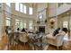 Spacious living room with high ceilings, a fireplace, and lots of natural light from large windows at 8710 Merion Dr, Duluth, GA 30097