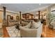 Open-concept living room with hardwood floors, stone accents, and a wet bar for entertaining at 8710 Merion Dr, Duluth, GA 30097