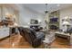 Living room with stone fireplace, built-in shelving, a bar, and hardwood floors at 8710 Merion Dr, Duluth, GA 30097