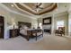 Main bedroom features a fireplace and decorative ceiling at 8710 Merion Dr, Duluth, GA 30097