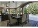 Covered outdoor dining area with seating for six and views of the pool and yard at 8710 Merion Dr, Duluth, GA 30097
