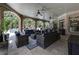 Elegant outdoor living space with brick arches, comfortable seating, and access to the pool at 8710 Merion Dr, Duluth, GA 30097