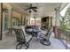 Covered patio featuring an outdoor stone fireplace and a wrought iron dining set at 8710 Merion Dr, Duluth, GA 30097