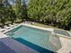 Inviting pool and spa with travertine surround, lounge chairs, and an outdoor fire pit at 8710 Merion Dr, Duluth, GA 30097