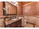 Elegant powder room with a marble vanity, designer mirror, and decorative tile accents at 8710 Merion Dr, Duluth, GA 30097