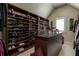 Spacious walk-in closet with custom shelving, granite island, and plenty of storage for shoes and clothing at 8710 Merion Dr, Duluth, GA 30097