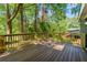 Wooden back deck surrounded by lush greenery, offering a private outdoor space at 1675 Avon Sw Ave, Atlanta, GA 30311