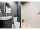 Stylish bathroom with modern vanity, a patterned shower curtain, and tiled walk-in shower at 1675 Avon Sw Ave, Atlanta, GA 30311