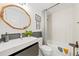 Updated bathroom with a modern vanity, a wood-trimmed mirror, and a shower-tub combination at 1675 Avon Sw Ave, Atlanta, GA 30311