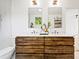 Bathroom featuring a modern double vanity, dual sinks, and contemporary lighting at 1675 Avon Sw Ave, Atlanta, GA 30311