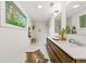 Bathroom featuring a double vanity, a large window, and a tiled walk-in shower at 1675 Avon Sw Ave, Atlanta, GA 30311