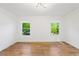 Bright bedroom featuring hardwood floors, white walls, and modern lighting at 1675 Avon Sw Ave, Atlanta, GA 30311