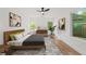 Modern bedroom with hardwood floors, contemporary decor, and large windows overlooking a lush yard at 1675 Avon Sw Ave, Atlanta, GA 30311