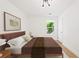 Charming bedroom with a full-sized bed, light fixture, and natural light from the window at 1675 Avon Sw Ave, Atlanta, GA 30311