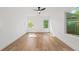Bright bedroom featuring hardwood floors, white walls, and natural light from two windows at 1675 Avon Sw Ave, Atlanta, GA 30311