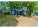 Exterior view showcasing the home's well-maintained lawn and mature trees at 1675 Avon Sw Ave, Atlanta, GA 30311