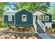 Charming blue home with white trim, inviting front porch, and meticulously landscaped front yard at 1675 Avon Sw Ave, Atlanta, GA 30311
