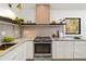 Close-up of the kitchen with modern appliances, stylish countertops, and a view to the outside at 1675 Avon Sw Ave, Atlanta, GA 30311