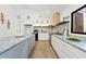 Contemporary kitchen showcasing granite countertops, white and gray cabinets, and stainless steel appliances at 1675 Avon Sw Ave, Atlanta, GA 30311