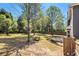 Spacious backyard with mature trees and lawn featuring a fenced perimeter at 1699 Boulder Walk Se Dr, Atlanta, GA 30316