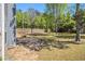 Expansive backyard with mature trees and lawn featuring a small patio area at 1699 Boulder Walk Se Dr, Atlanta, GA 30316