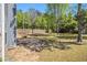 Expansive backyard showcasing a spacious lawn, mature trees, partial patio, and a tall privacy fence at 1699 Boulder Walk Se Dr, Atlanta, GA 30316