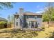 Spacious backyard view showcasing the home's exterior with a patio and well-maintained lawn at 1699 Boulder Walk Se Dr, Atlanta, GA 30316
