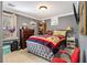 Bedroom featuring a bed with a patterned quilt, dresser, and window at 1699 Boulder Walk Se Dr, Atlanta, GA 30316
