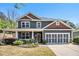 Charming two-story home featuring a welcoming front porch and a well-maintained, landscaped front yard at 1699 Boulder Walk Se Dr, Atlanta, GA 30316