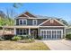 Charming two-story home with a well-manicured lawn and inviting covered front porch at 1699 Boulder Walk Se Dr, Atlanta, GA 30316