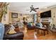 Living room with fireplace, hardwood floors, ceiling fan and view to eat-in kitchen at 1699 Boulder Walk Se Dr, Atlanta, GA 30316