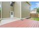 Backyard featuring a wooden deck, green grass, and the house's siding, perfect for outdoor living at 433 Orchid Ln, Canton, GA 30114