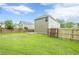 Large backyard featuring a wooden deck, green grass, house with siding and a wood fence at 433 Orchid Ln, Canton, GA 30114