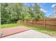 Backyard featuring a wooden deck, green grass, and a wood fence, perfect for outdoor living at 433 Orchid Ln, Canton, GA 30114