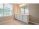 Bright bathroom featuring a double sink vanity with a large mirror and a window offering natural light at 433 Orchid Ln, Canton, GA 30114