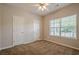 Cozy bedroom featuring a ceiling fan, neutral walls, and a large window at 433 Orchid Ln, Canton, GA 30114