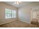 Bedroom featuring a ceiling fan, neutral walls, and a large window at 433 Orchid Ln, Canton, GA 30114