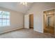Bedroom with plush carpet, a large window, and a closet, offering a comfortable and well-lit space at 433 Orchid Ln, Canton, GA 30114