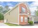 Two-story home featuring brick and siding, with a side-entry garage and landscaped front yard at 433 Orchid Ln, Canton, GA 30114