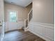 Front foyer with hardwood floors, stairs and wainscoting at 433 Orchid Ln, Canton, GA 30114