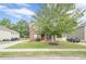 Traditional two-story brick home with manicured lawn, mature tree, and inviting curb appeal at 433 Orchid Ln, Canton, GA 30114