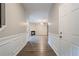 Hallway with hardwood floors that leads to an open floor plan with living room and fireplace at 433 Orchid Ln, Canton, GA 30114