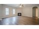 Open living room featuring a fireplace, hardwood floors, and natural light from large windows at 433 Orchid Ln, Canton, GA 30114