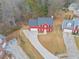 Aerial view of a two story home with a red exterior, a gray roof, and a long driveway at 1029 Chaterly Ct, Riverdale, GA 30296