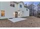 View of backyard featuring house elevation, small patio, and tree line at 1029 Chaterly Ct, Riverdale, GA 30296